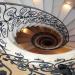 Looking down on a wrought iron balustrade spiraling over four flights encompassing a floral design by Michael Jacques, sculptor and Master Blacksmith